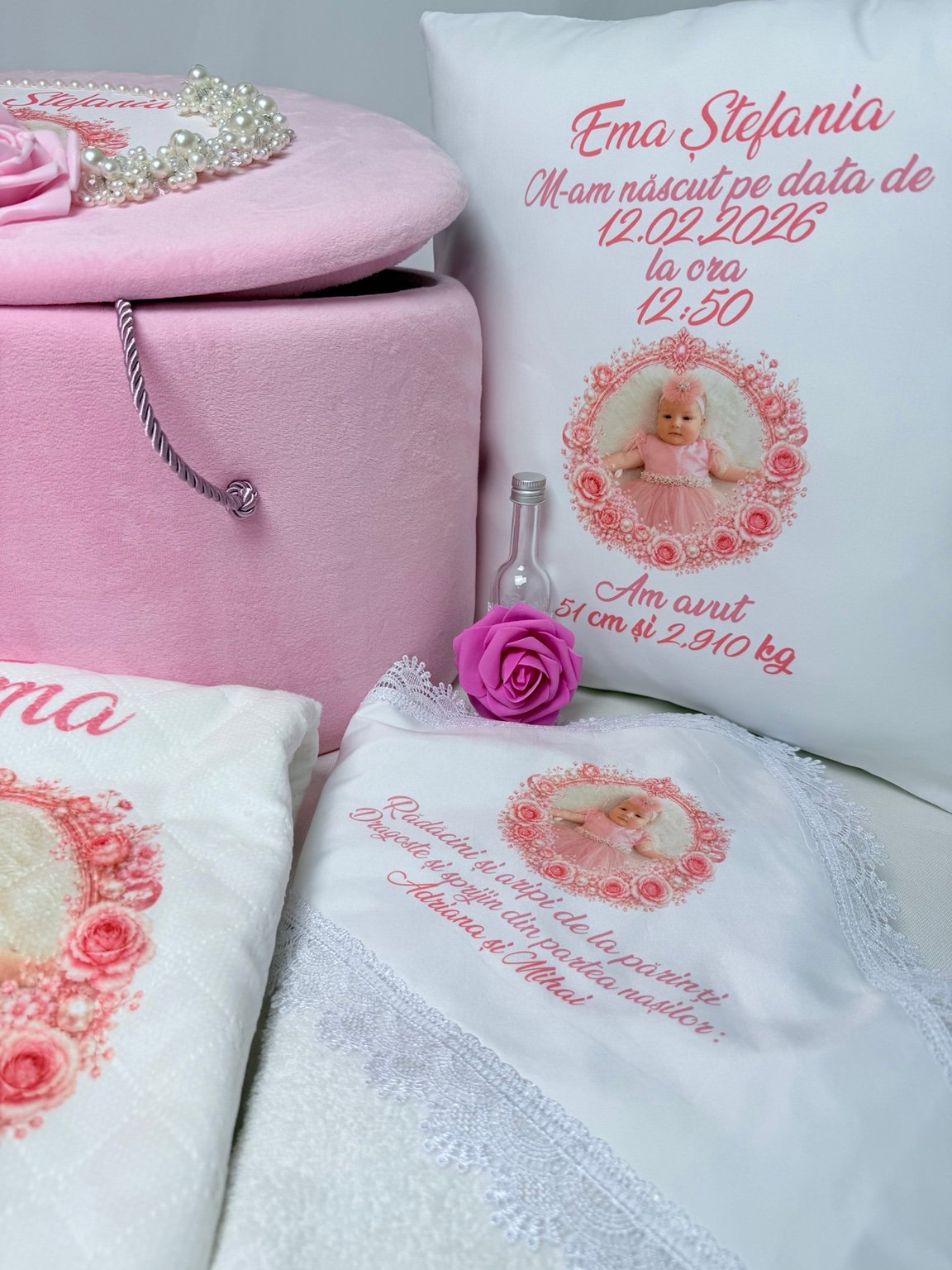 Pernă personalizată cu fotografie și datele nașterii, lângă sticluța pentru mir cu trandafir fucsia